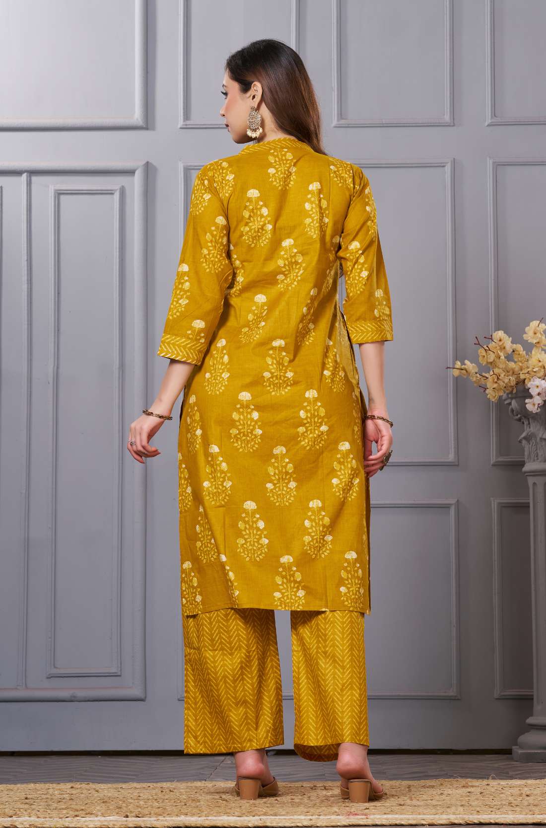 The rear view of the teal blue kurta set - showcasing the clean tailored back - and the monochromatic styling of the ethnic suit.