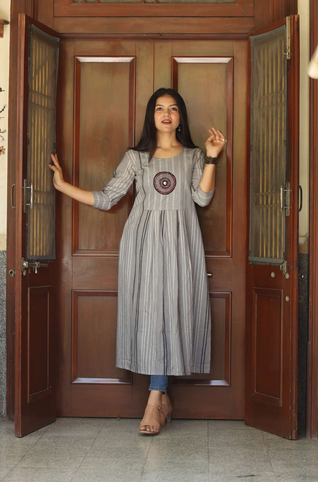 Grey cotton a line kurti with circle embroidery full front view in pose mode.