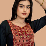 Black hand enbroidery and block print detail on yoke showing front view.