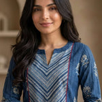 Close-up of the round neckline with contrast diagonal striped yoke, red piping, and white floral hand block print detailing on an indigo pure cotton kurta.