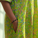 Close-up of the functional side pocket on the lime green pure cotton frock style dress with Jaipur floral print and Kantha stitch detailing.
