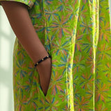 Close-up of the functional side pocket on the lime green pure cotton frock style dress with Jaipur floral print and Kantha stitch detailing.