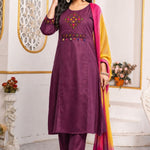 Model wearing a magenta pure cotton kurta pant set featuring multicolour geometric cross-stitch embroidery with mirror detailing, three-quarter sleeves, straight-fit pants and an ombre tie-dye chiffon dupatta.