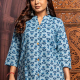 Close-up front view of powder blue short kurti in pure cotton featuring traditional hand block floral print, mandarin notch neck, wooden buttons and comfortable everyday fit.