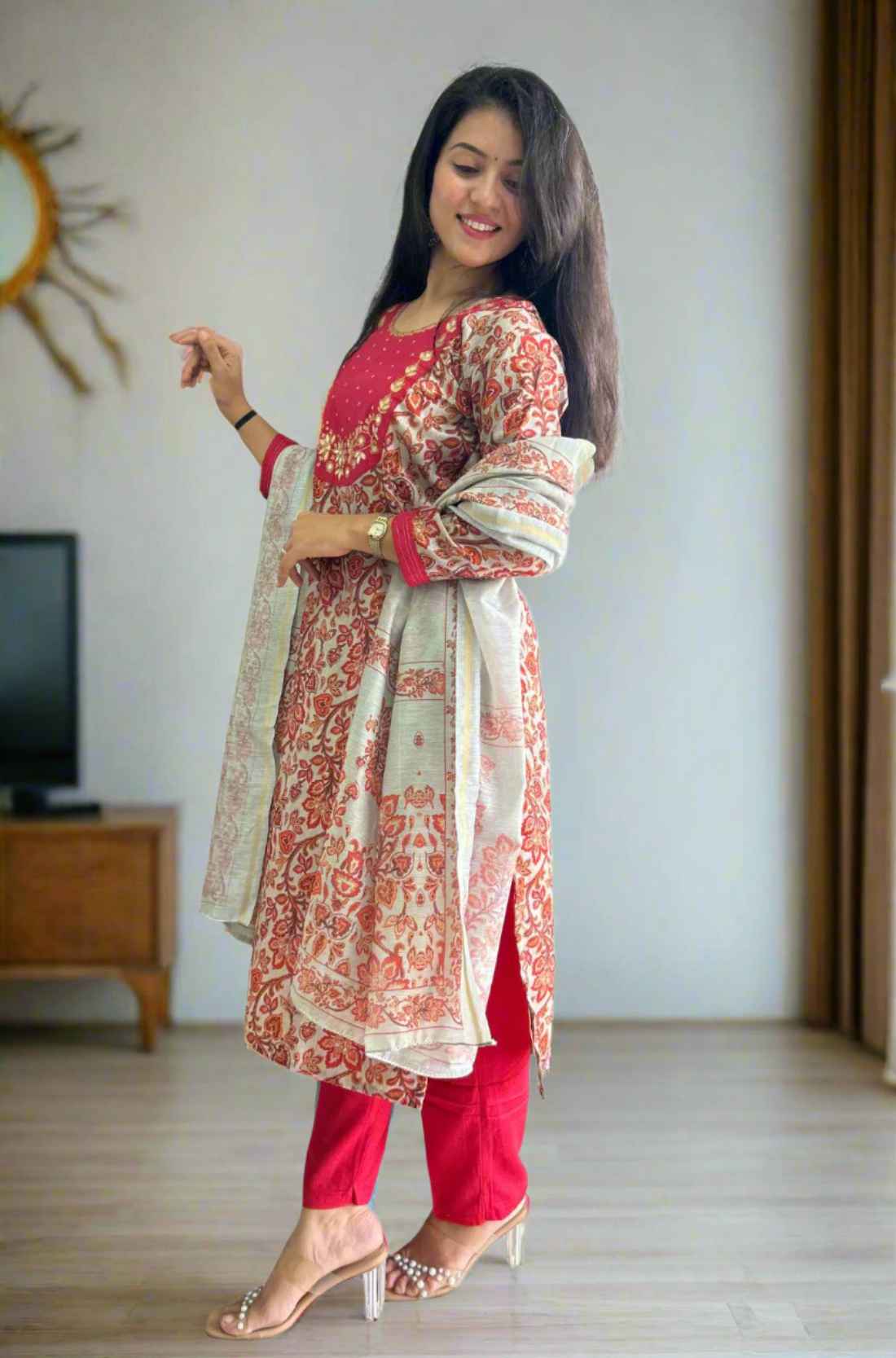 Side pose in red printed kurta with beige dupatta.