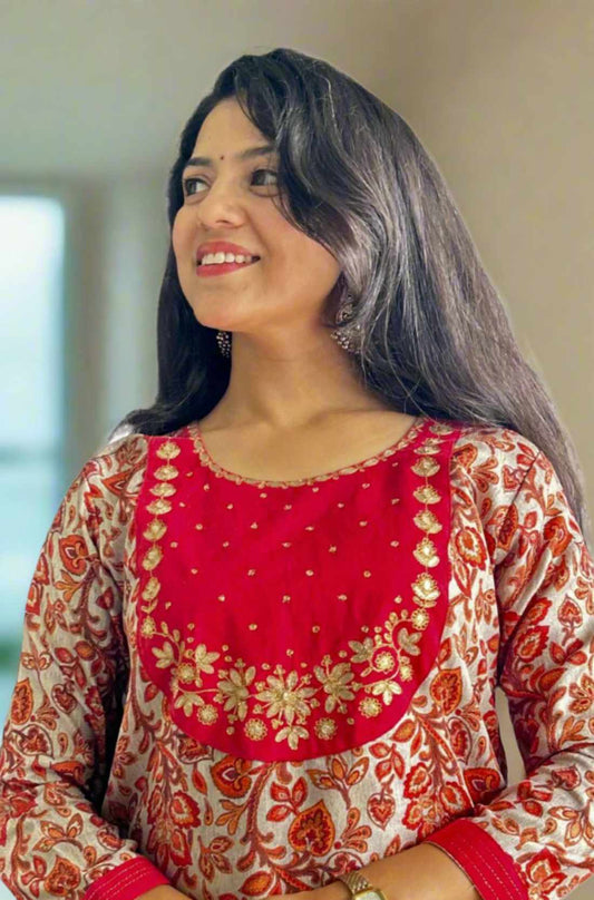 Close-up of a red printed kurta with an embroidered neckline.