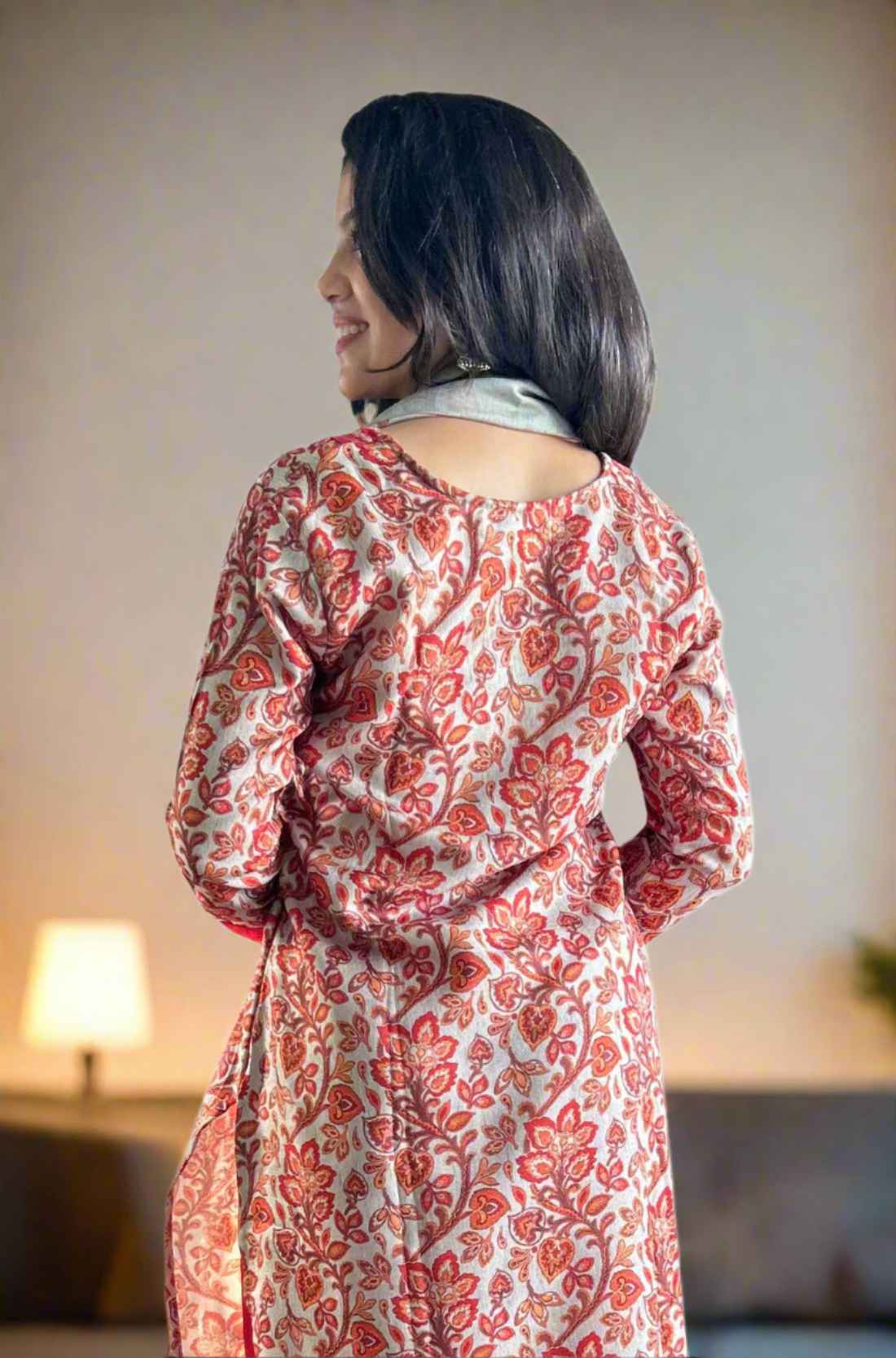 Back view of red kurta set with circle print detail.