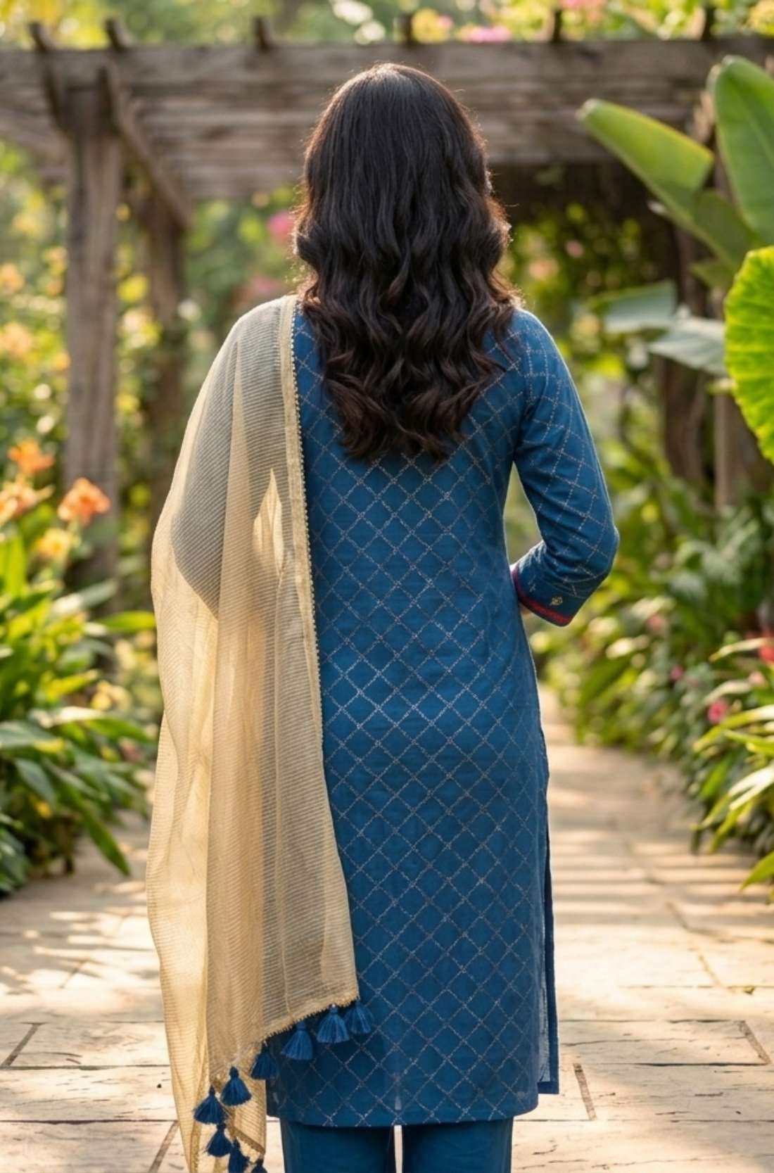 Back view of the royal blue anti-crease crepe kurta set showing the straight-fit silhouette, matching trousers, and elegant gold lycra dupatta with tassel detailing.