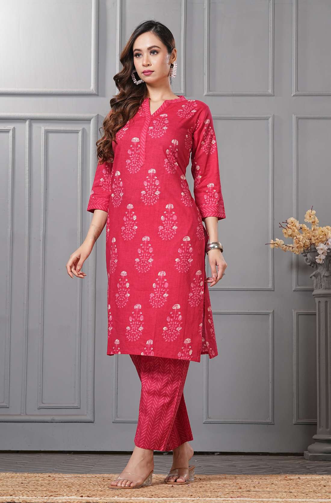 A full-length front-angle pose in a wine-colored ethnic suit - highlighting the elegant drape of the fabric - and the detailed embroidery on the sleeves.