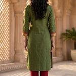 Back view of women's dark green cotton straight-fit kurti with three-quarter sleeves, calf-length design, side slits, and a clean back, paired with maroon pants.