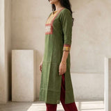 Side profile of women's dark green cotton hand block print kurti featuring side slits, three-quarter sleeves with contrast borders, and a straight-fit silhouette.