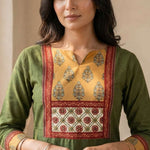 Front view of women's dark green cotton hand block print kurti featuring a round neckline, mustard and red contrast patch yoke, three-quarter sleeves, and a straight calf-length silhouette.