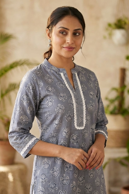 Front view of women's grey cotton straight-fit kurti featuring white block print motifs, a round neckline with lace-accented yoke, three-quarter sleeves with lace cuffs, and breathable cotton fabric.