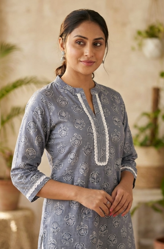 Front view of women's grey cotton straight-fit kurti featuring white block print motifs, a round neckline with lace-accented yoke, three-quarter sleeves with lace cuffs, and breathable cotton fabric.