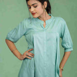 Half-length front view of women's sea green rayon shirt featuring a mandarin collar, button-down front, subtle pleats, and relaxed fit for office and casual styling.