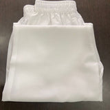 Folded women's white straight-fit cotton pants featuring a comfortable elastic waistband, breathable fabric, and versatile styling for kurtis and ethnic wear.