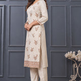 Side view of women’s beige embroidered silk blend kurta set with matching pants.