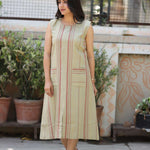 Model walking in sleeveless beige striped A-line kurti