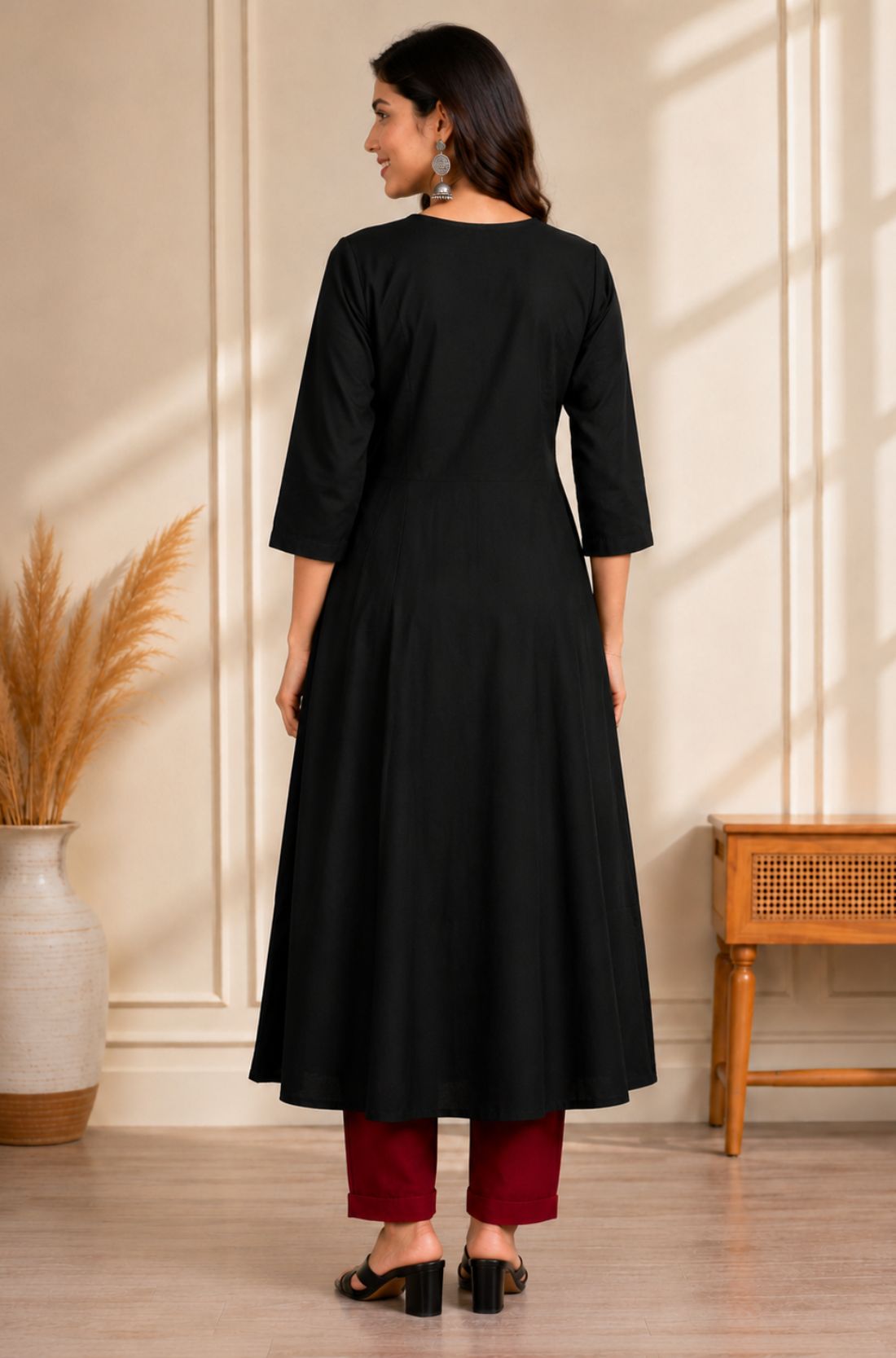 Back view of black A-line rayon kurta for women with 3/4 sleeves and flared fit