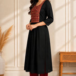 Side view of black hand embroidered A-line rayon kurta for women with block print yoke