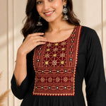 Close-up of hand embroidery, mirror work and block print yoke on black rayon kurta