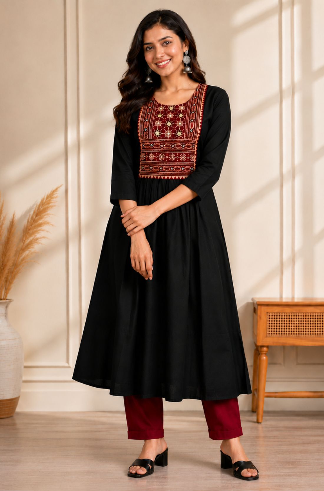 Black A-line kurta for women with hand embroidery, mirror work and block print yoke