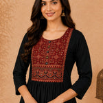 Close-up of black rayon kurta with hand embroidery, block print and mirror work on the front yoke