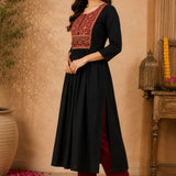 Side-angle view of black rayon A-line kurta with embroidered front yoke, three-quarter sleeves and flared hem