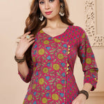 Close up view of the elegant V neckline design showcasing white lace inserts and border trims on a bright pink cotton floral print kurta