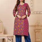 Front full length view of a model wearing a bright pink cotton floral print kurta set with matching pocketed straight pants