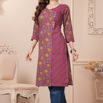 Side profile view of a model in a bright pink floral printed cotton ethnic suit showcasing the clean straight-cut fall
