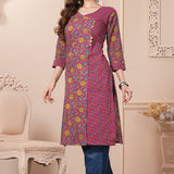 Side profile view of a model in a bright pink floral printed cotton ethnic suit showcasing the clean straight-cut fall