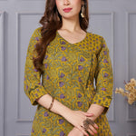 Close up view of the elegant neckline design showcasing white lace inserts and border trims on a mustard yellow cotton floral print kurta
