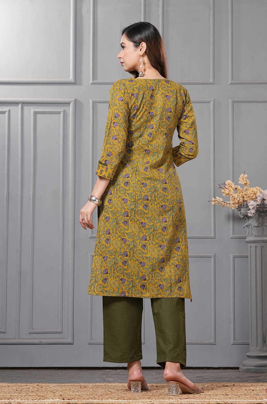 Back view of the mustard yellow straight fit cotton floral kurta set highlighting the clean print alignment