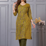 Side profile view of a model in a mustard yellow floral printed cotton ethnic suit showcasing the regular fit and elegant side slit profile