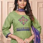 Detailed close up macro shot of the traditional cross stitch embroidery patterns surrounding the split crew neckline of a light green cotton kurta