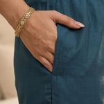 Close-up view highlighting the convenient functional side utility pocket tailored into the matching dark blue silk straight trousers, showing a hand resting inside the pocket.