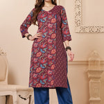 Front full length view of a model wearing a deep mudberry cotton floral print kurta set with matching pocketed straight pants