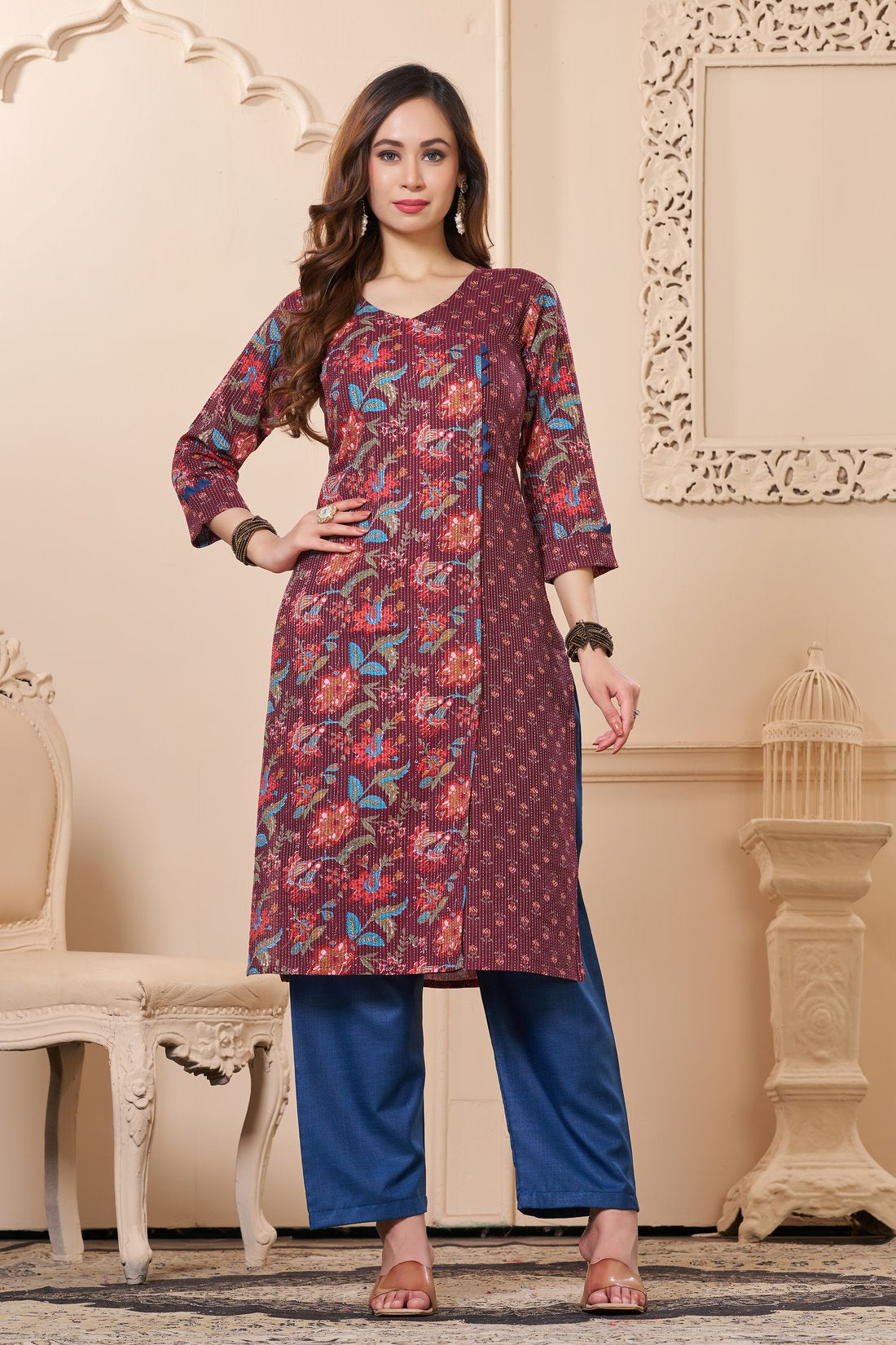 Front full length view of a model wearing a deep mudberry cotton floral print kurta set with matching pocketed straight pants