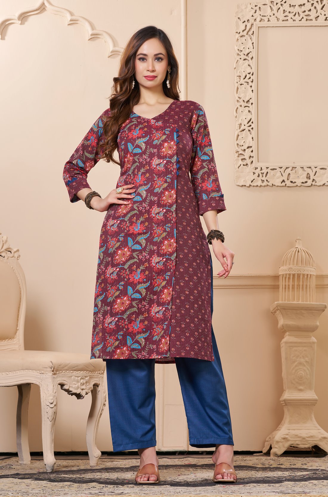Front full length view of a model wearing a deep mudberry cotton floral print kurta set with matching pocketed straight pants