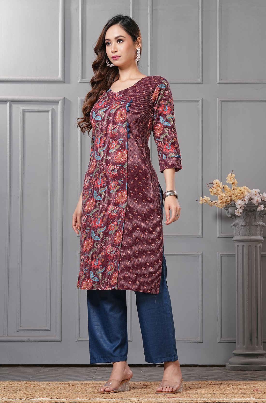 Side profile view of a model in a deep mudberry purple floral printed cotton ethnic suit showcasing the regular fit