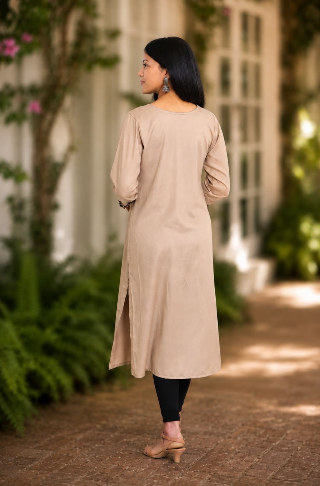 Back view of beige A-line rayon kurta with 3/4 sleeves and straight back fall