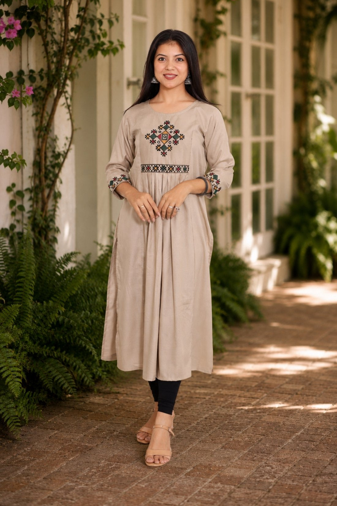 Embroidered beige A-line rayon kurta with cross stitch yoke and 3/4 sleeves, front view