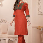 Side profile view of the straight-fit rust orange cotton kurta showcasing the pocketed pants and beautiful matching printed dupatta drape