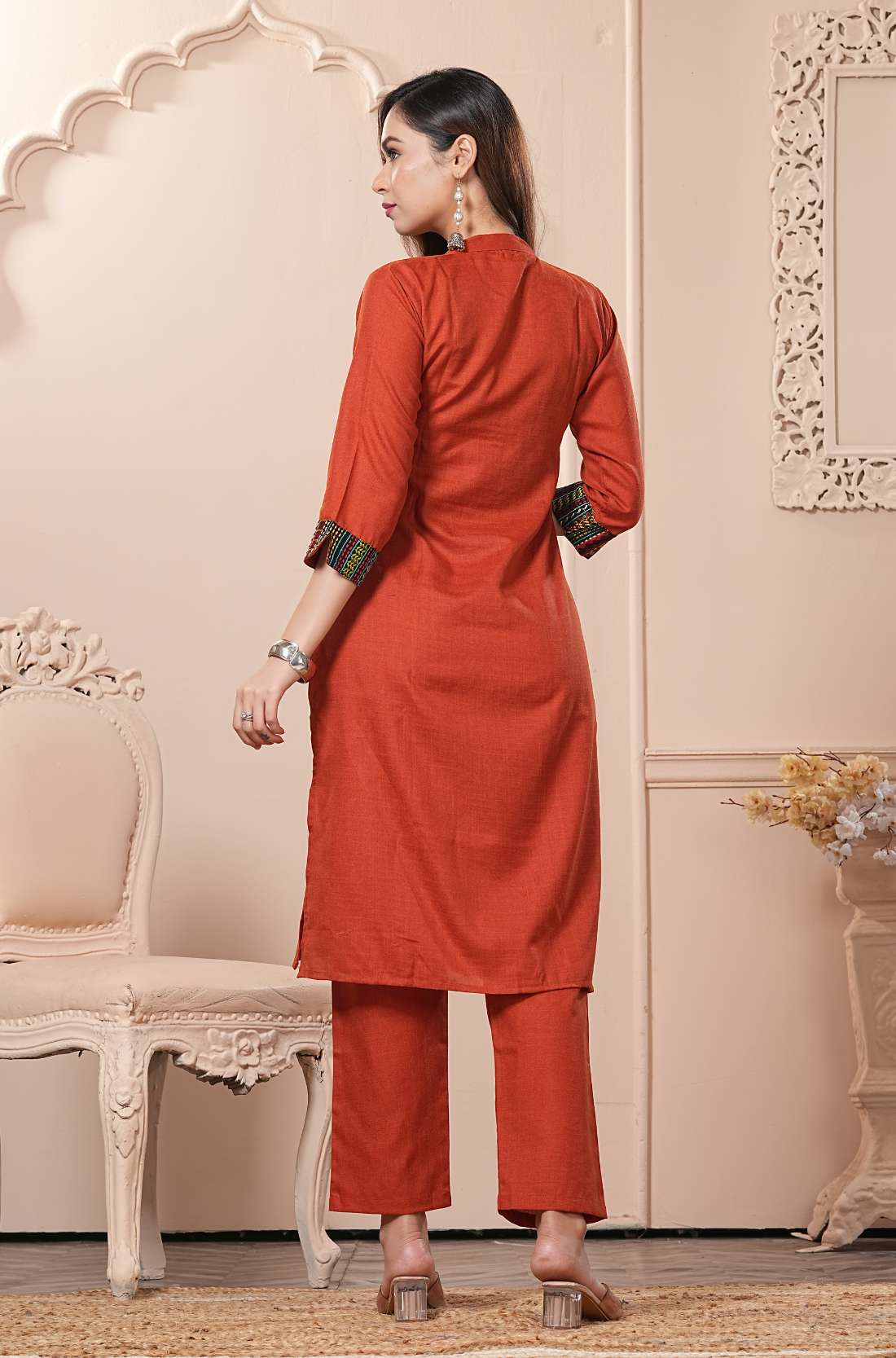 Back view of the straight fit rust orange cotton straight kurta set showing the comfortable trousers and clean back silhouette
