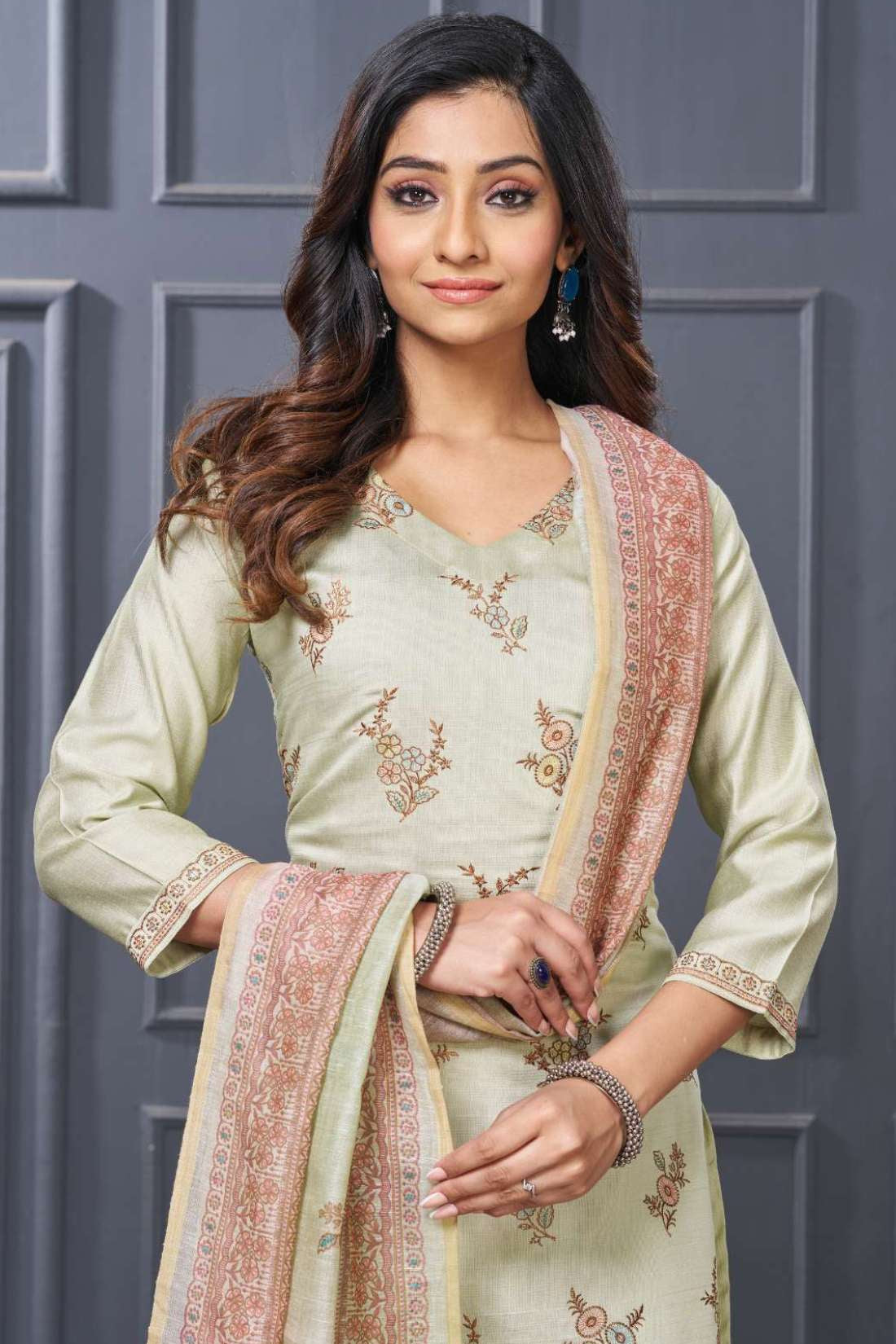 Front full length view of a model wearing a premium dark green silk kurta set featuring elegant scalloped borders and intricate thread embroidery, paired with a matching dupatta