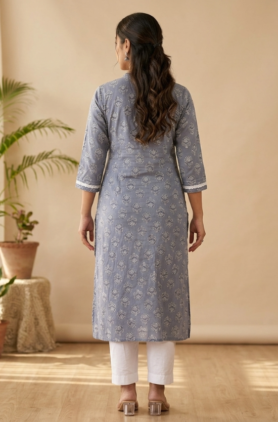 A rear view of a woman wearing a grey-blue printed straight kurta and white pants, highlighting the garment fit.