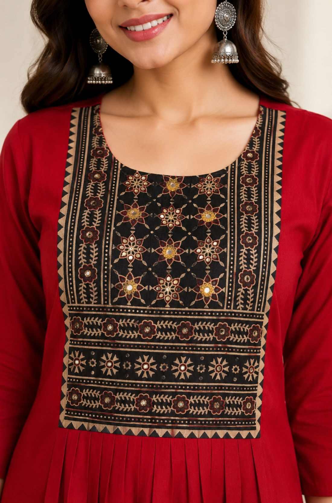 Close-up of hand embroidery, mirror work and block print on maroon rayon kurta for women