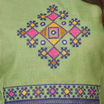 Detailed view of the intricately designed front yoke section on a light green cotton kurta featuring precise geometric and floral cross stitch needlework