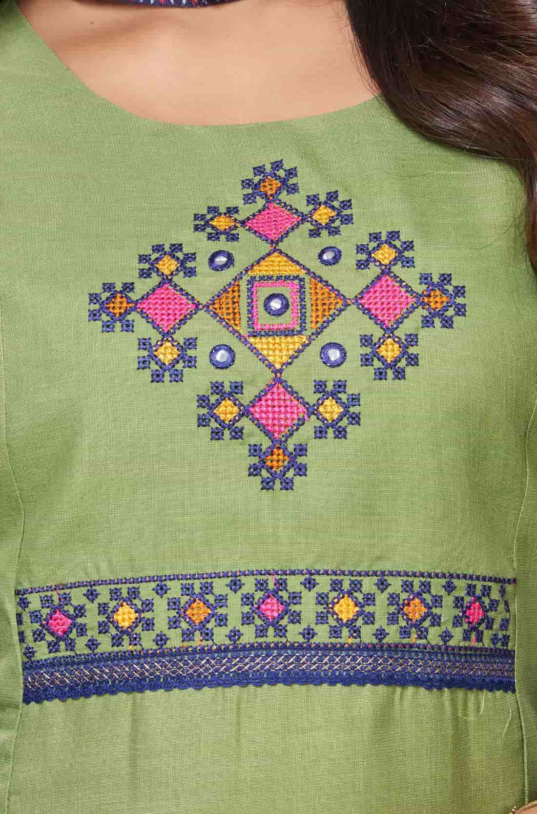 Detailed view of the intricately designed front yoke section on a light green cotton kurta featuring precise geometric and floral cross stitch needlework